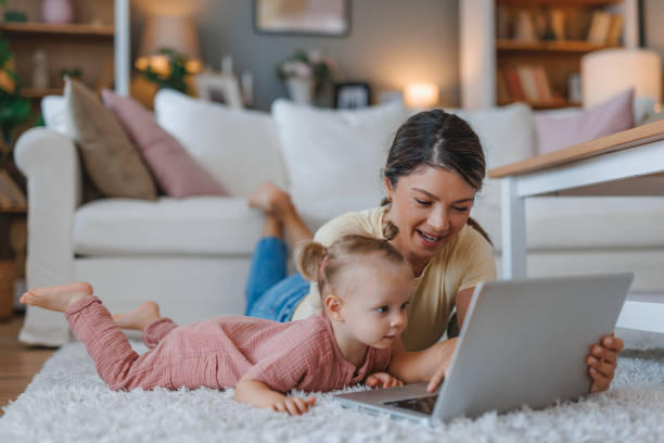 istock Playful moment between mother and child sharing laptop. 2159860722