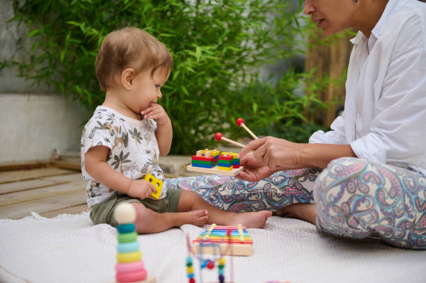 istock Toddler playing with mother during learning activity outdoors 2159860944
