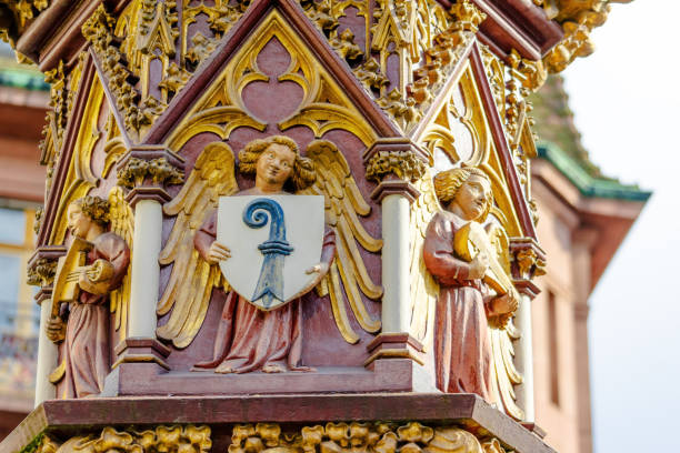 A large, ornate building with a gold and red color scheme. The building has a large, intricate design with many angels and other figures. The angels are holding various items, including a shield