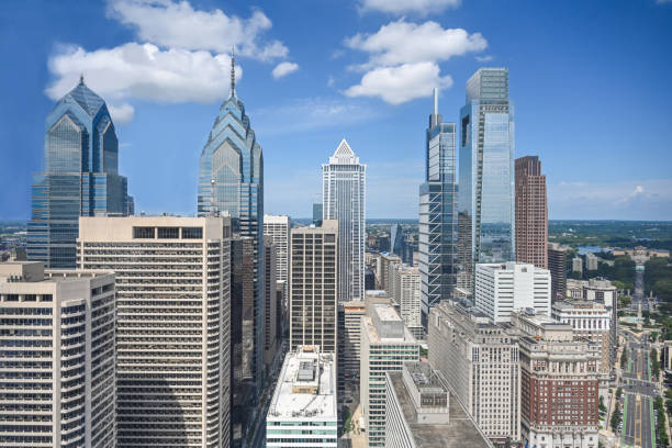 Philadelphia, USA - Traffic approaching on John F Kennedy Boulevard on a sunny day in springtime, with the city's downtown skyline on the horizon.