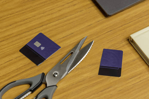 istock Cut credit card next to scissors on a table. 2159876502