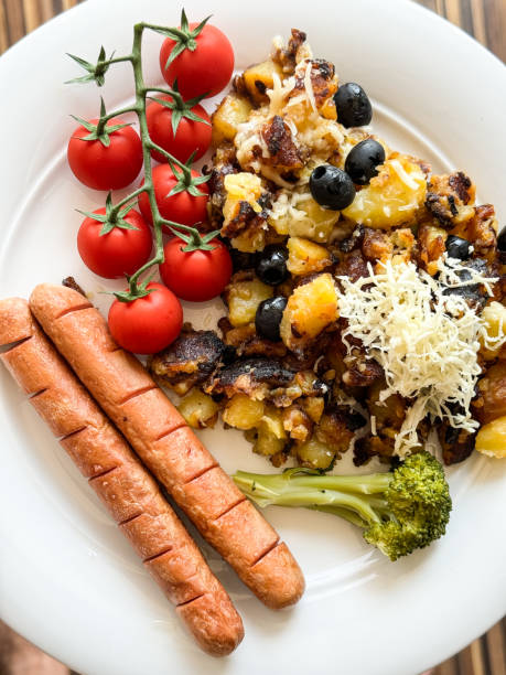 Vegetarian sausages with  roasted potatoes, cherry tomatoes, and broccoli