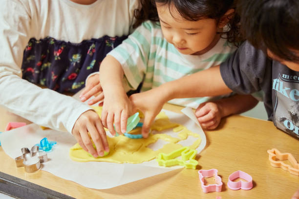 Sisters enjoying decorating cookies at home