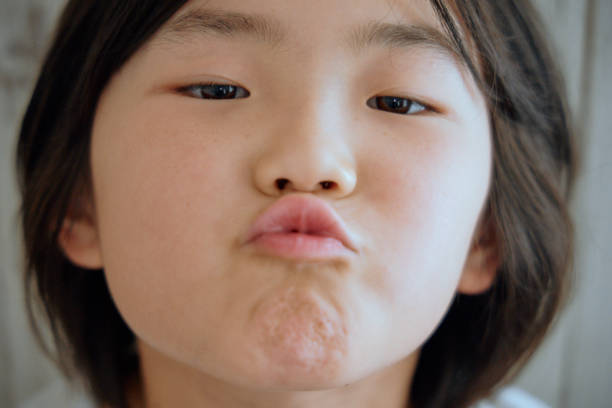Cropped view portrait of attractive cheerful hungry funny girl licking lip isolated over pink pastel color background.