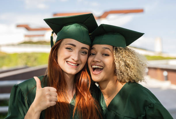 istock Two Happy Graduates Celebrating Together 2159894789