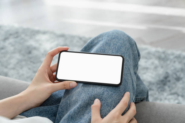 istock Hand holding smartphone mockup of blank screen for graphic display montage. 2159897472