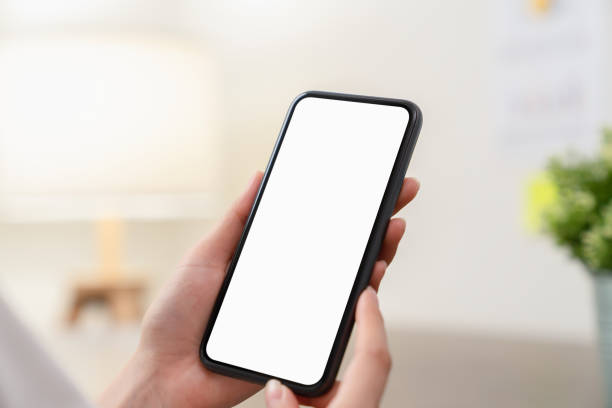 istock Hand holding smartphone mockup of blank screen for graphic display montage. 2159897473