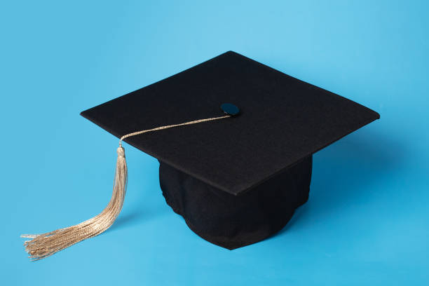 small mortarboard with scroll of certificate.