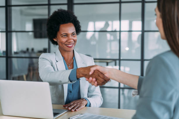 istock Business persons shaking hands across the table. 2159902059