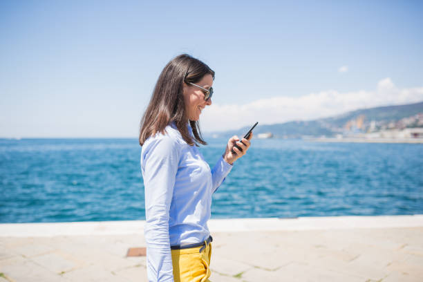istock Seaside Stroll with Smartphone on a Sunny Day 2159902757