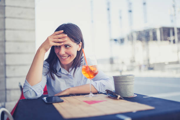 istock Woman Enjoying Refreshing Drink Outdoors in Daylight 2159902821