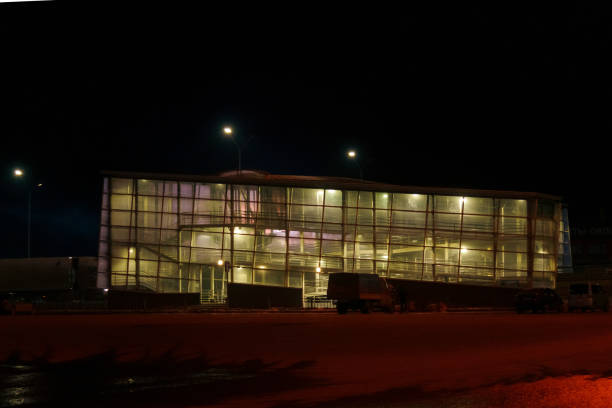 istock Windows glowing Illuminated Multi-Windowed Building at Night. Crossing the automobile highway 2159904416