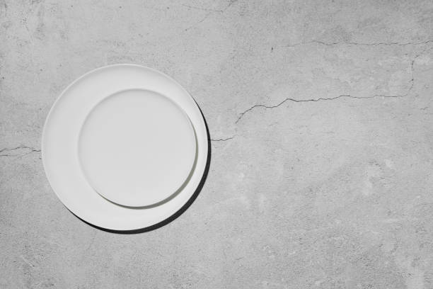 istock Overhead view of two plates over concrete background 2159904805