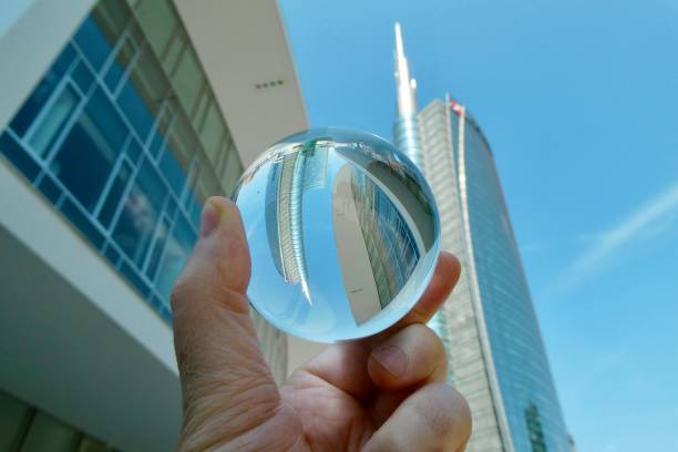 istock Hand holding crystal ball with skyscrapers background 2159907675