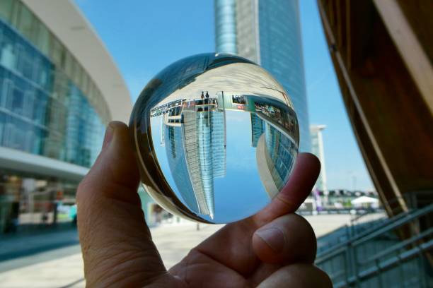 istock Hand holding crystal ball with skyscrapers background 2159908003