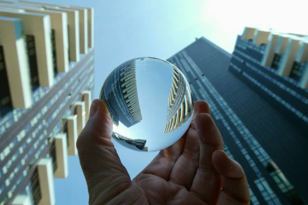 istock Hand holding crystal ball with skyscrapers background 2159908589