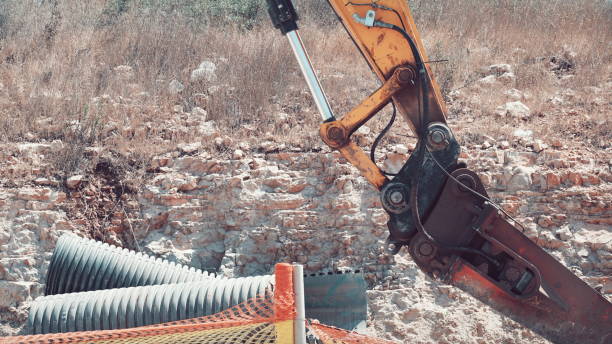 istock Excavator Arm Over Stone Wall Construction Site Color 2159912180