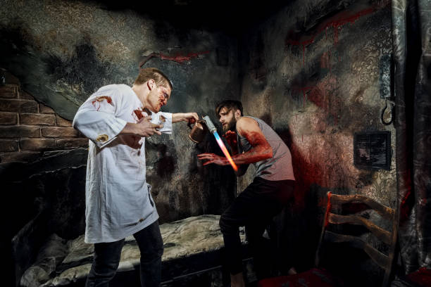 istock Psycho killer tortures with gas burner miserable victim 2159912926