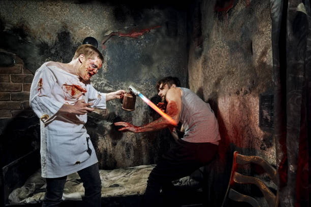 istock Psycho killer tortures with gas burner miserable victim 2159912930