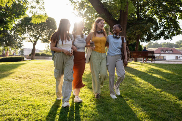 istock Multiracial female university students walking together through the campus park 2159914441