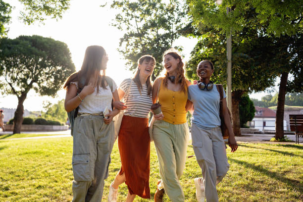 istock Multiracial female university students walking together through the park 2159914469