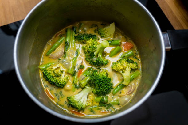 istock Chef at the kitchen preparing green curry with herbs and rice 2159915726