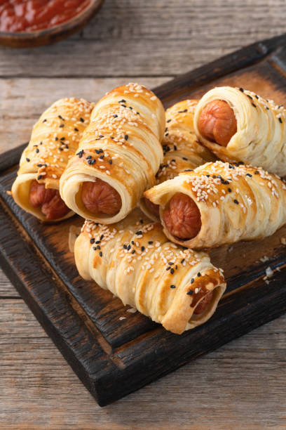 istock Homemade Sausage in dough rolls on plate 2159916605