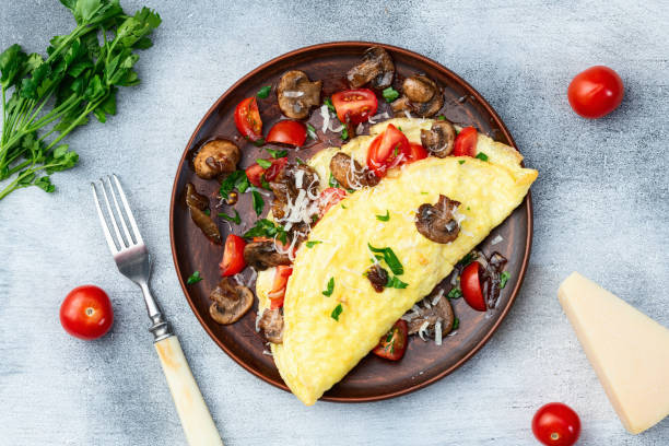 istock Omelette stuffed with mushrooms , tomatoes and parsley 2159916703