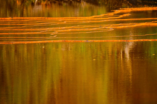Sunset illuminates the terraced mineral pools, showcasing the vibrant geological layers at Rio Tinto