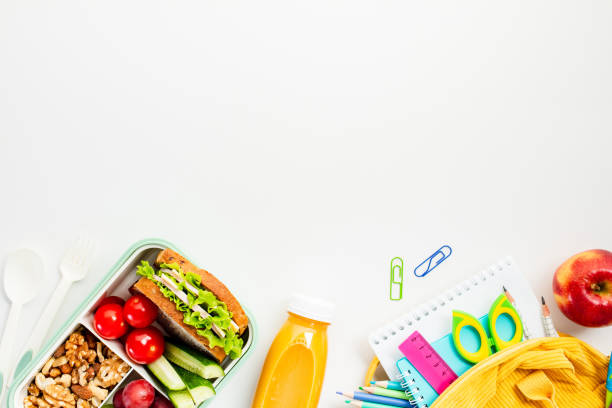 istock Flat lay composition with nutritious lunchbox meals with sandwiches and fruits, alongside essential school supplies. Perfect for educational and promotional needs with sample space for your text 2159920172