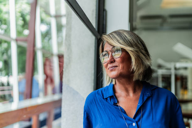 istock Mature woman contemplating on library 2159920644