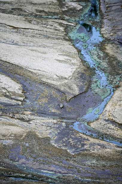 istock Striated Rock Formations with Acidic Water Channels 2159921114
