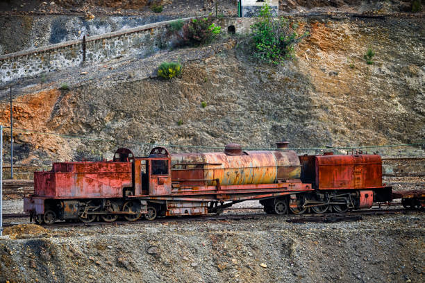 Weathered mining equipment, including trucks and rail cars, sits in the historic Rio Tinto mines, a testament to past industry