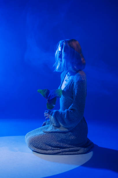 Woman with flower in studio.