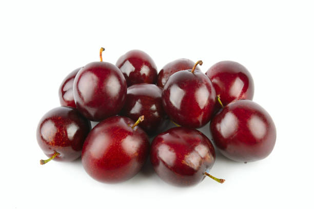 istock plums isolated on white background. 2159925477