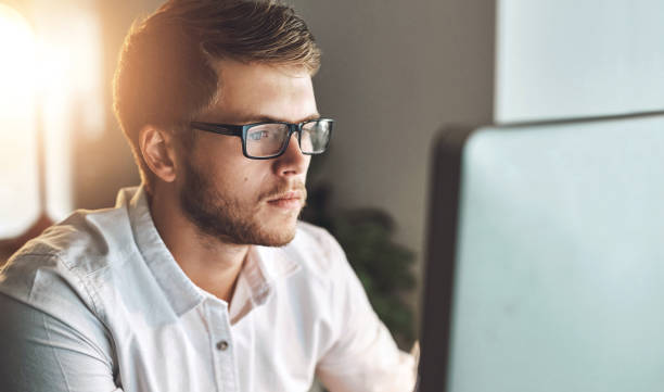 istock Computer, glasses and man in office for research on software development for project with technology. Reading, career and male coder working online for database system on desktop in workplace. 2159926339
