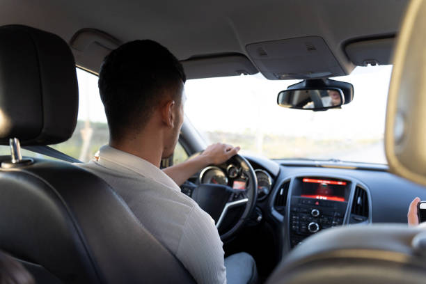 istock Young man driving a car. 2159927027