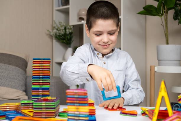 istock A schoolchild plays with a magnetic construction set. Interesting educational toys. 2159927710