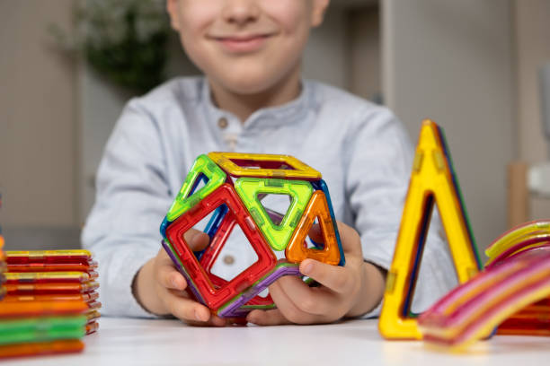 istock Child playing with magnetic constructor, hands close-up. 2159927717