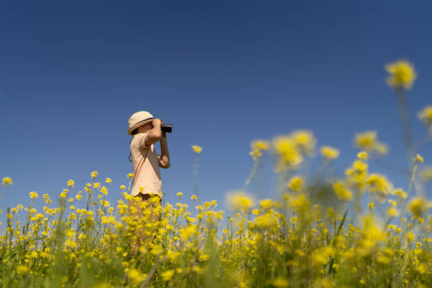 istock Boy observing blooming nature 2159929674