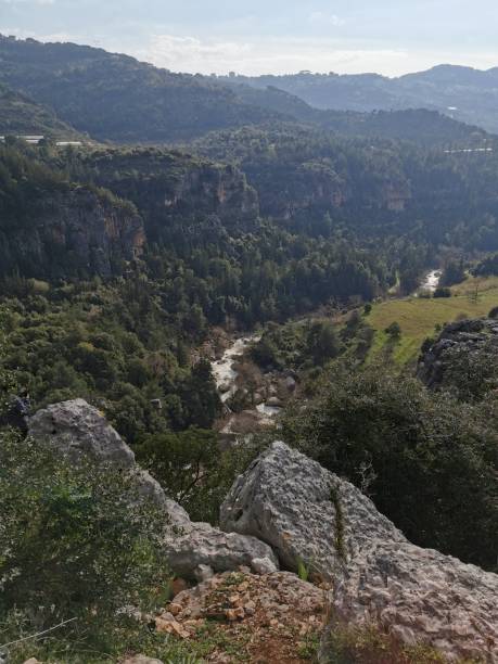 istock Scenic mountain landscape with dense forests, rocky cliffs, and a winding river 2159930475