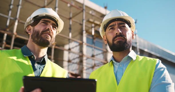 istock Thinking, tablet and engineering team at outdoor construction site, industrial planning and building development. Teamwork, digital survey and inspection of architecture builder or people with vision 2159933126
