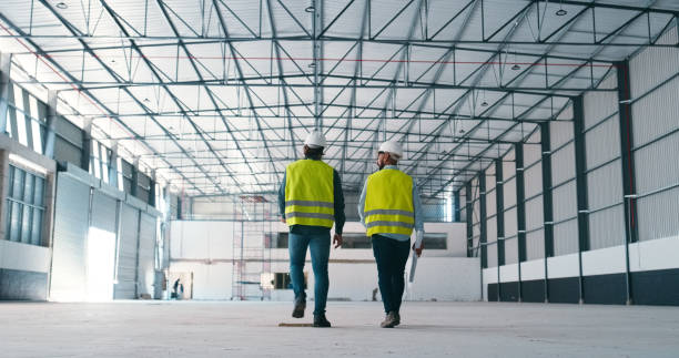 istock Construction, walking and men in building for planning, maintenance and storage inspection. Civil engineering, teamwork and contractors brainstorming for manufacturing, warehouse and factory design 2159933198