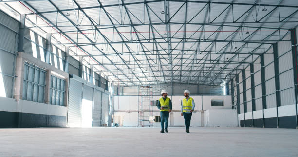 istock Construction, warehouse and men in building for planning, maintenance and inspection for storage. Civil engineering, teamwork and contractors in meeting for manufacturing, discussion and factory 2159933199