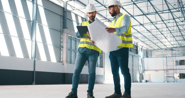 istock Blueprint, tablet and engineering team in building planning, collaboration and property development or design progress. Floor plan, project management and contractor on digital tech for architecture 2159933211