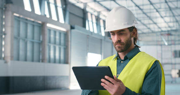 istock Planning, tablet and engineering with man in warehouse for industrial, architecture and construction. Manufacturing, networking and digital with contractor for project management and development 2159933213