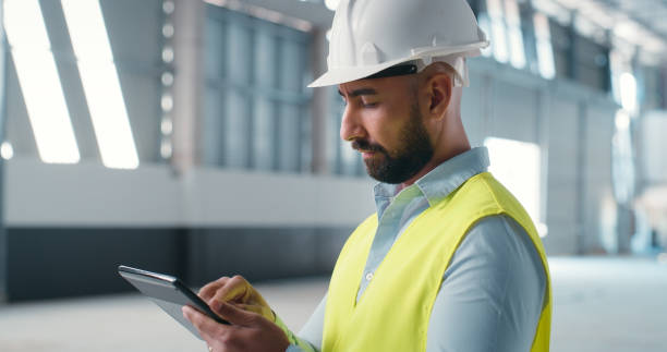 istock Digital, tablet and engineering with man in warehouse for industrial, architecture and construction. Manufacturing, networking and planning with contractor for project management and development 2159933220