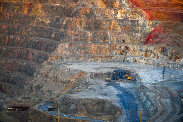 istock Dusk Over Multicolored Open Pit Mine with Equipment 2159942485