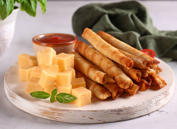 istock Turkish cigar borek with sauce on a board 2159947143