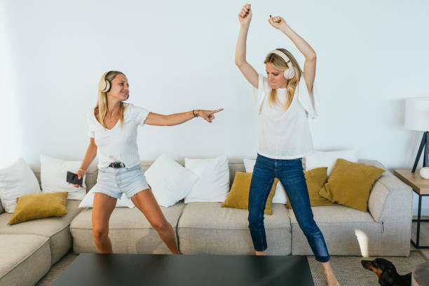 istock Cheerful women dancing while listening to music 2159950159
